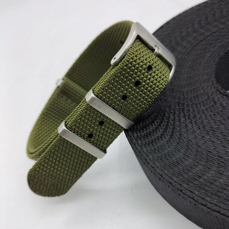 Nylon quick-release watch strap in army green, showing the integrated spring bar mechanism.