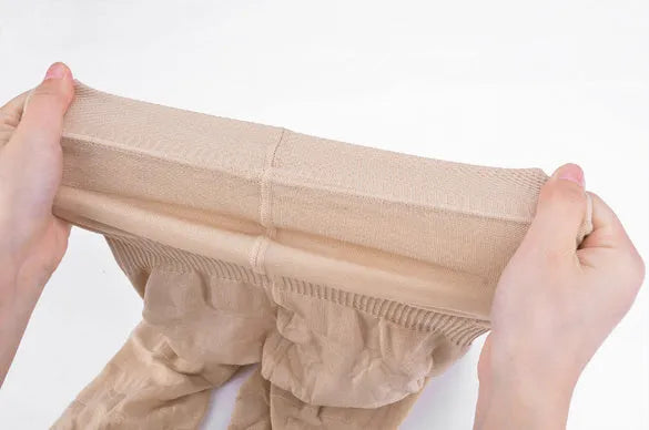 Women's black seamless high waist shapewear shorts laid flat, showing the tummy control panel.
