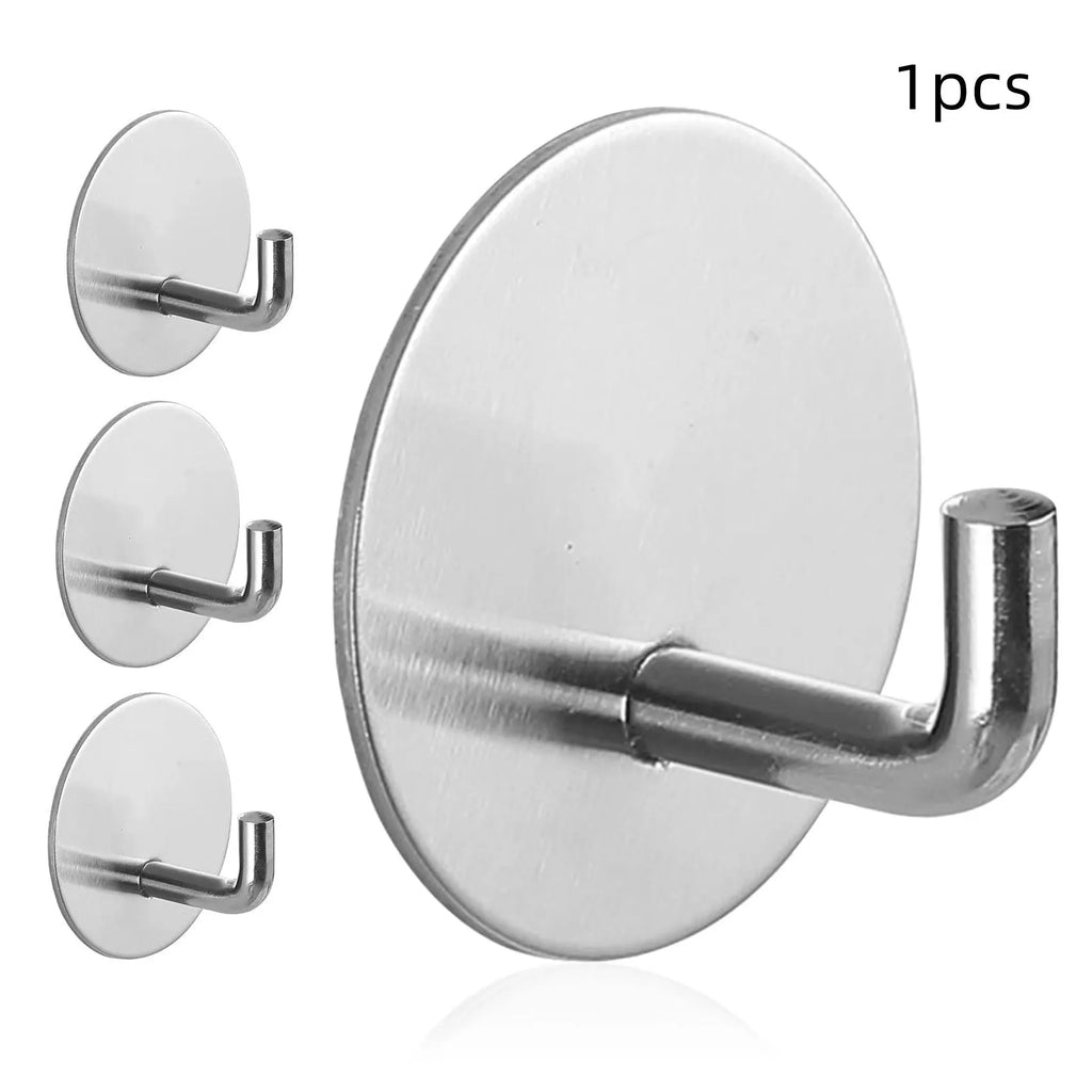 Two stainless steel self-adhesive hooks on a surface, one black and one polished.