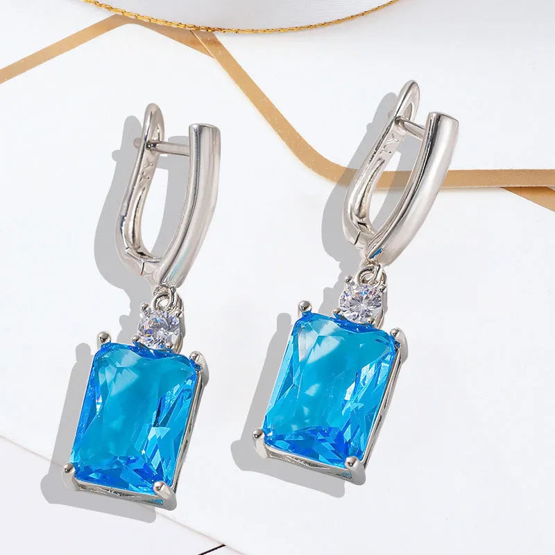 Square geometric copper earrings with gold electroplated finish showing quadrilateral shape