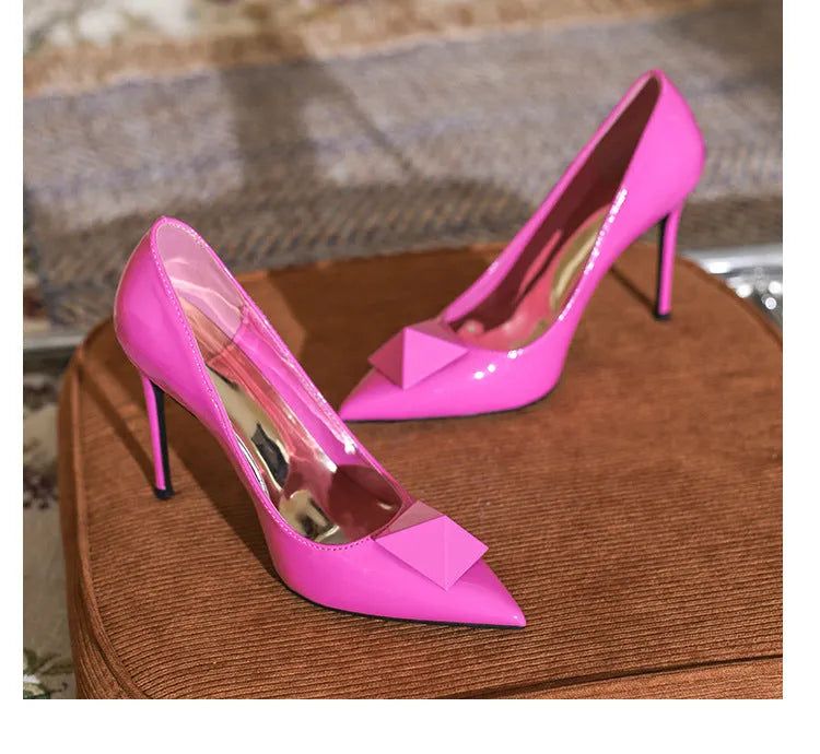 Women's pink patent leather pointed toe stiletto high heels with buckle and rivet decoration