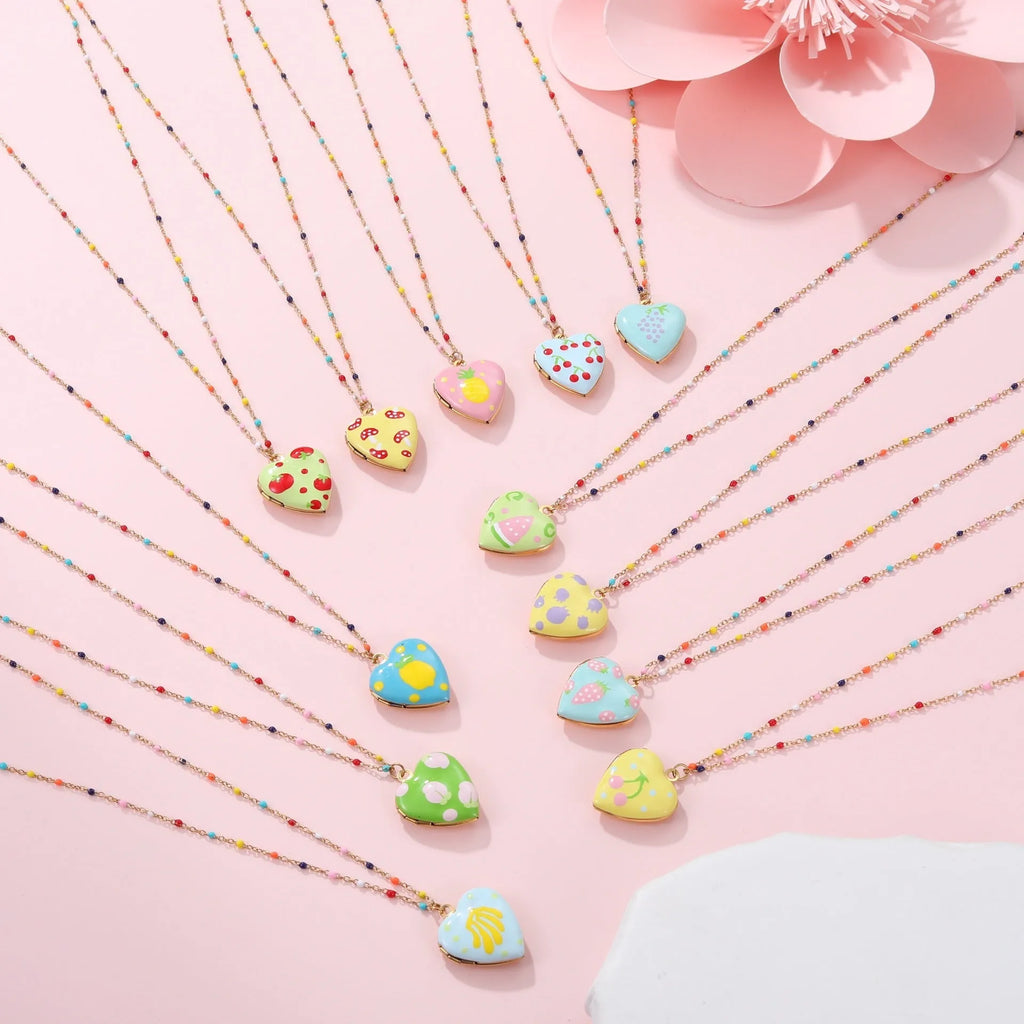 Women's stainless steel necklace with 18K gold plating showing heart pendant with fruit designs