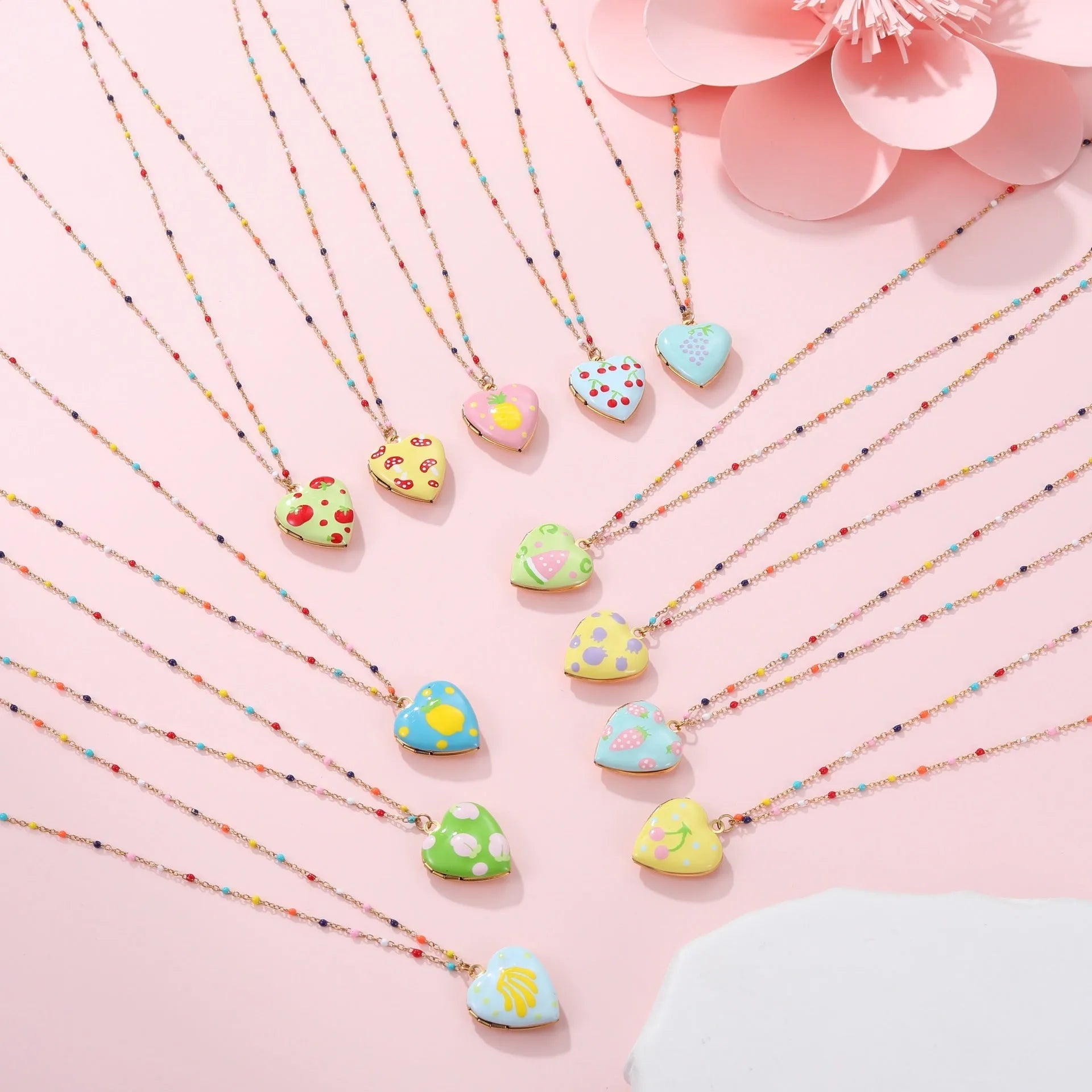 Women's stainless steel necklace with 18K gold plating showing heart pendant with fruit designs