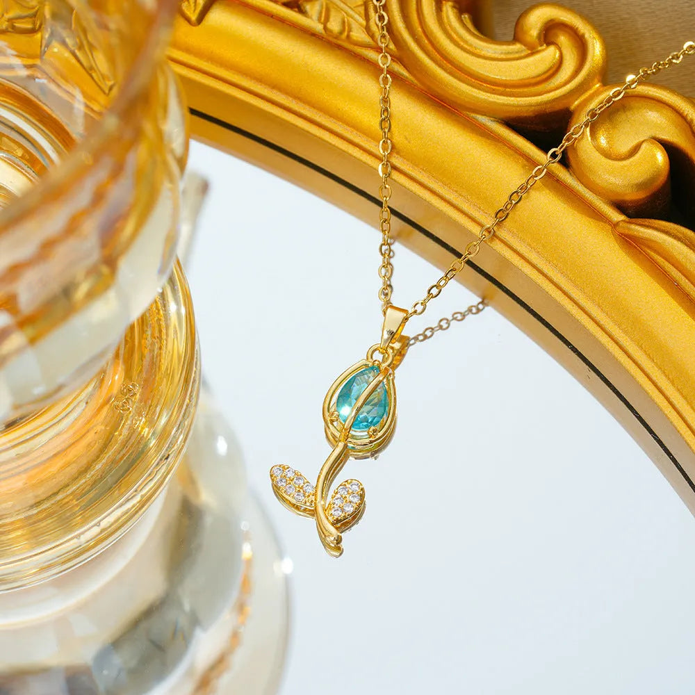 Gold zircon tulip flower pendant necklace on an adjustable titanium steel chain.