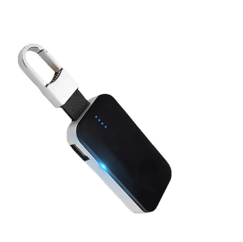Black portable keychain power bank for wireless charging of Apple Watch on a white background.