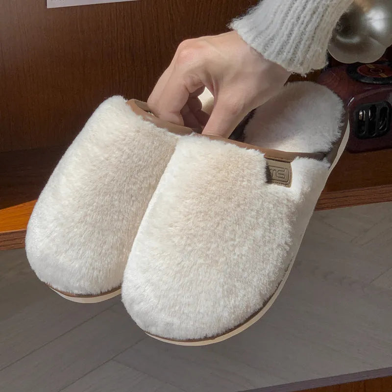 Solid colour PVC plush slippers with non-slip sole and car stitching detail on a wooden floor.