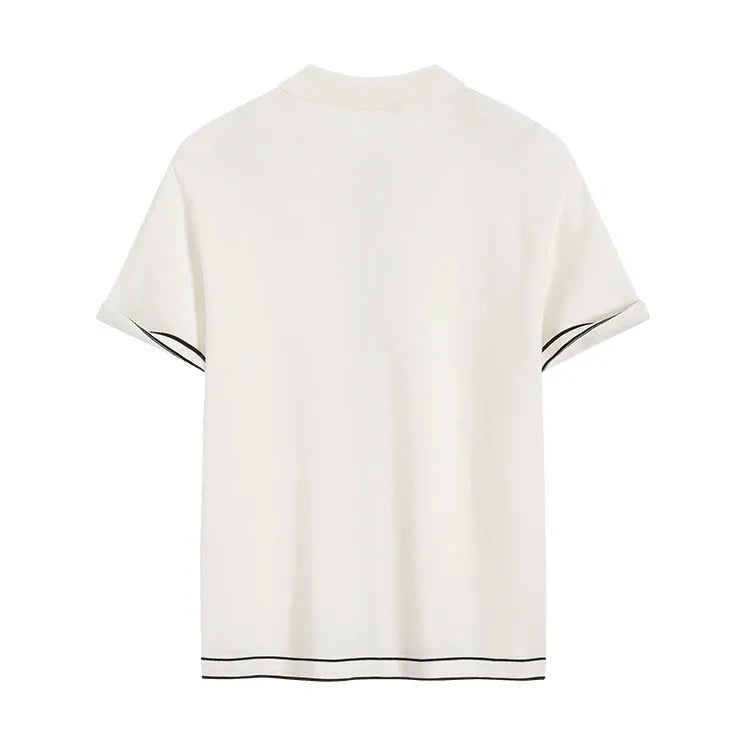 White short-sleeved cardigan with dark contrast lapels laid flat.