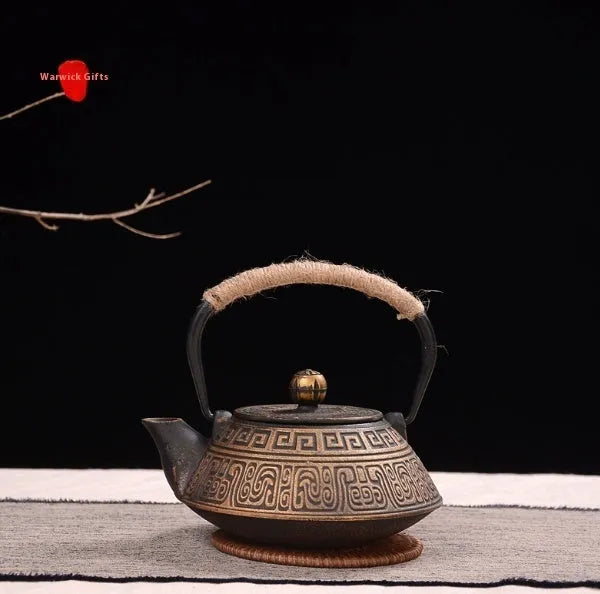 A cast iron teapot with Japanese-style hand-painted decoration, shown in a Bronze finish, with a capacity of 0.9 litres.