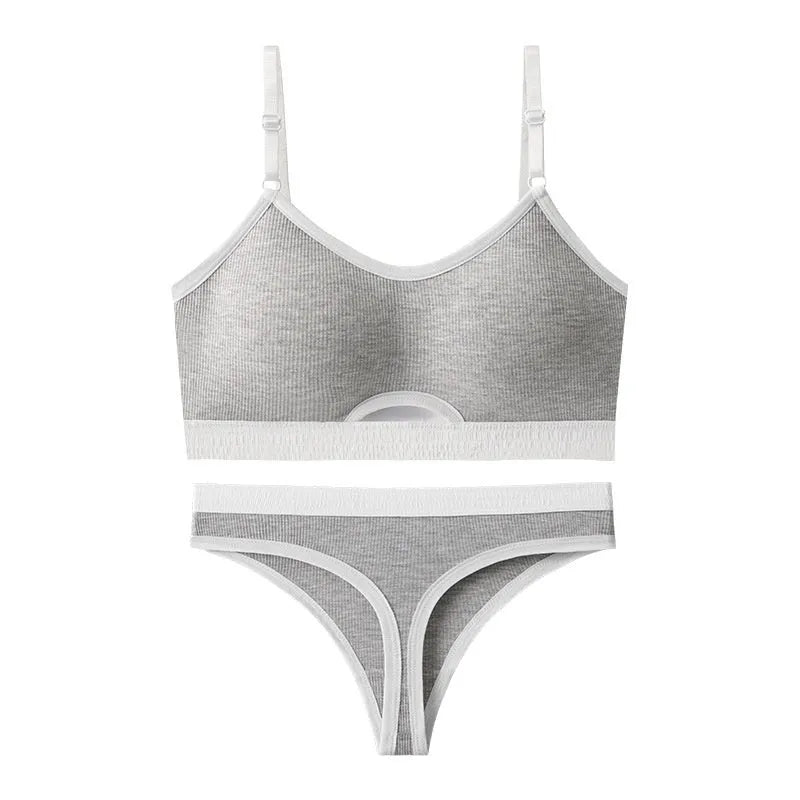 White sports underwear vest with contrast back detail and matching underwear, shown on a hanger.