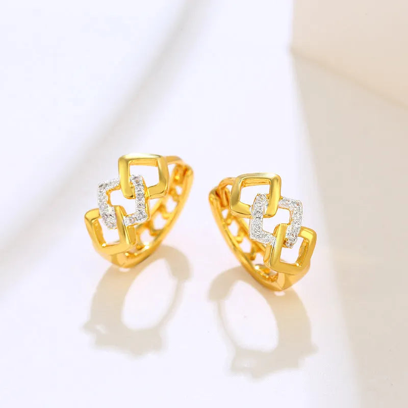 Geometric hollow-out gold-colour alloy earrings with an ear clip fastening.
