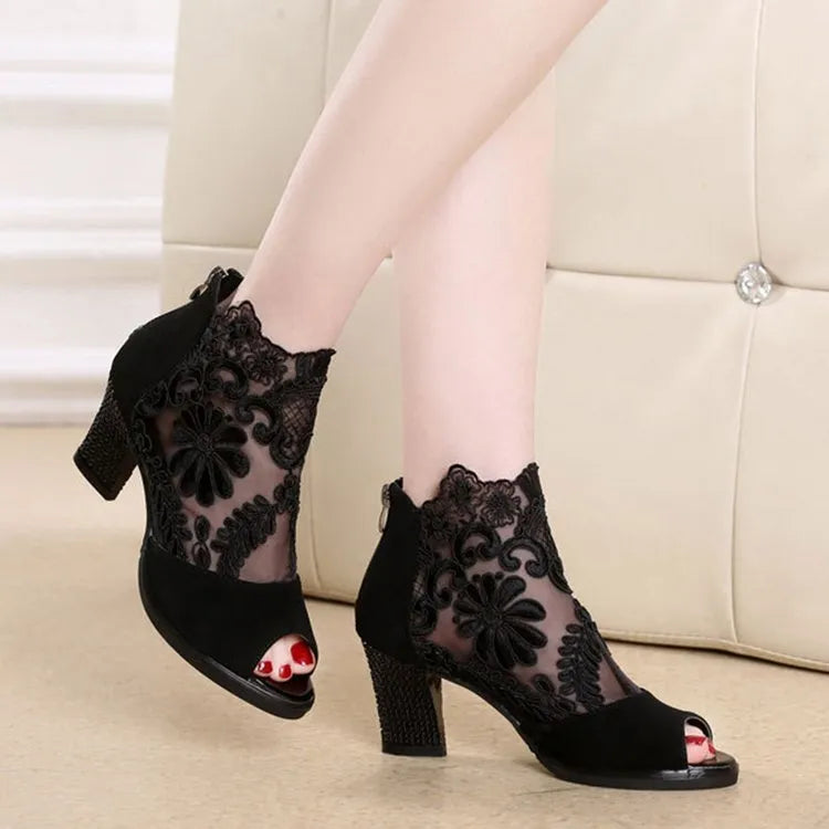 Women's black lace gladiator sandals with square heel and zip closure showing floral patterns