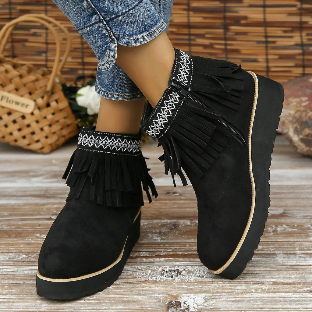 Women's black suede wedge ankle boots with side zip, tassel, and thick rubber sole.