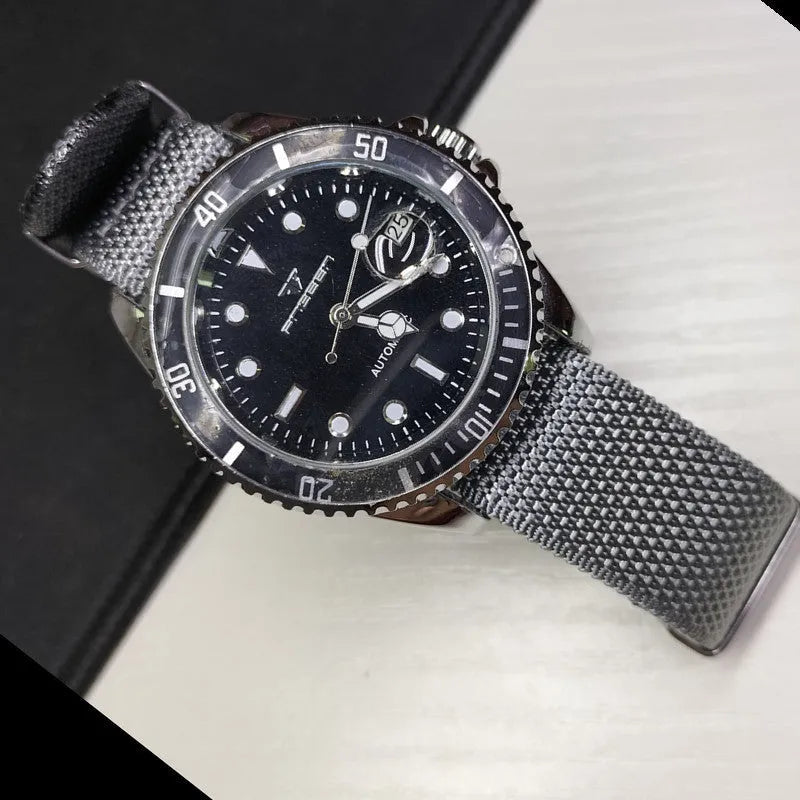 Nylon quick-release watch strap in army green, showing the integrated spring bar mechanism.