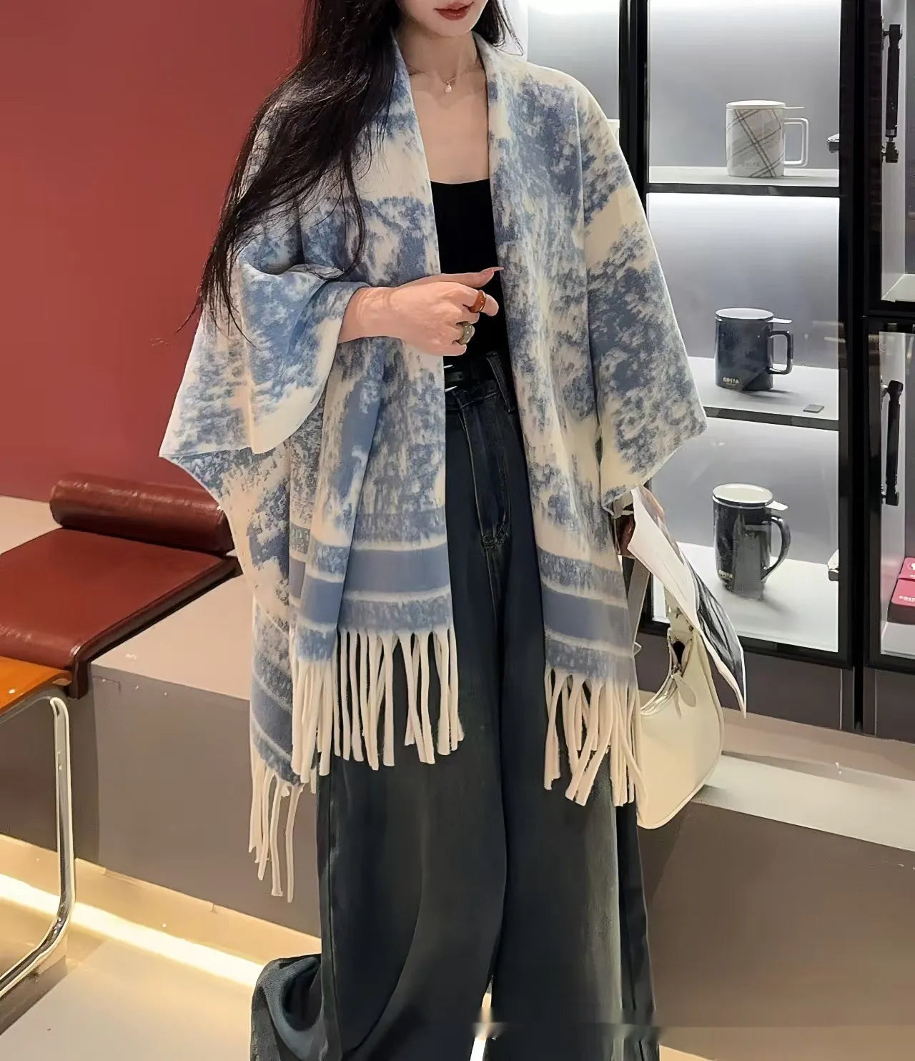 Women's polyester tassel scarf cape draped over shoulders showing fringe detailing