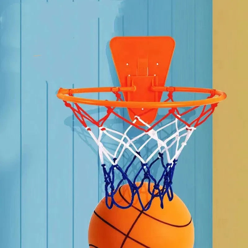 Silent high density foam sports ball in assorted bright colours next to a basketball frame.