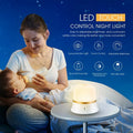 White rechargeable touch control night light with dimmer and motion sensor on a bedside table.