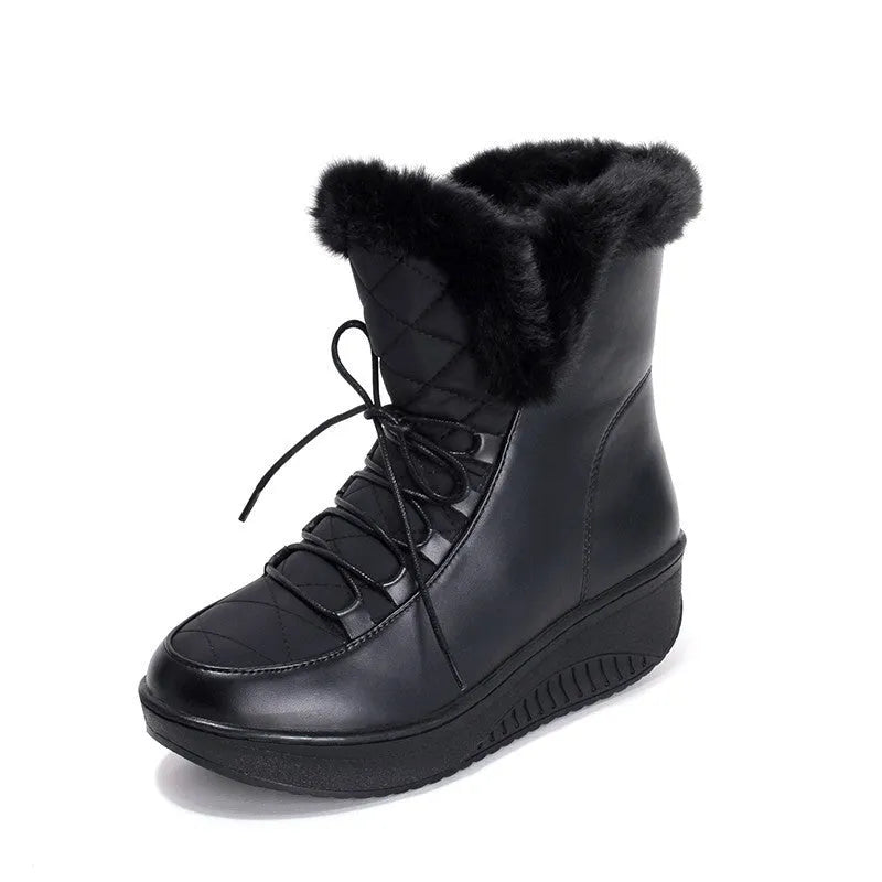 Women's black lace-up winter boots with a platform sole and plush lining on a wooden floor.