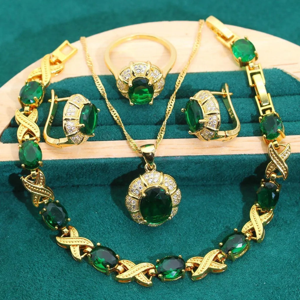 Gold coloured necklace, earrings, ring, and bracelet set with blue synthetic cubic zirconia stones.