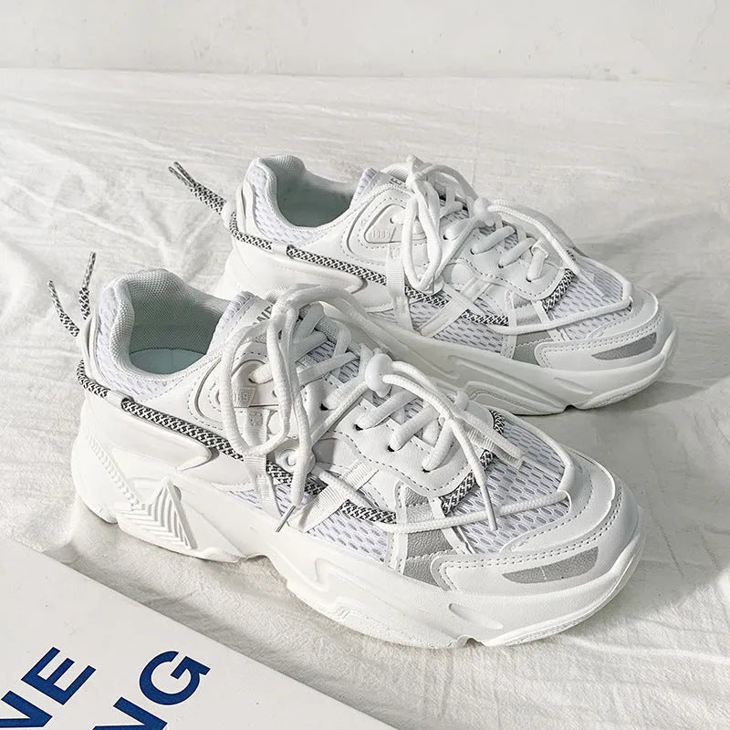 A pair of men's white Korean-style platform sports shoes with a lace-up front.