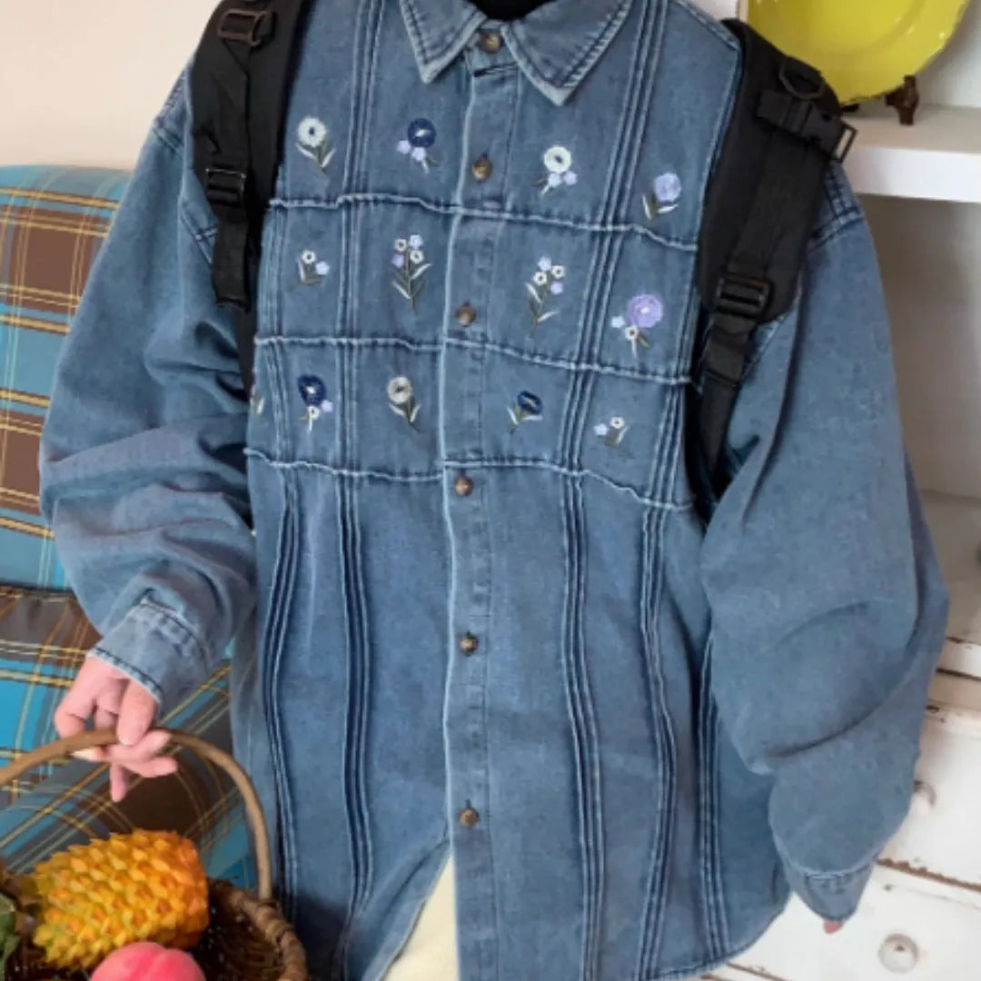 Vintage washed blue denim long sleeve shirt with small floral print and pleated details.