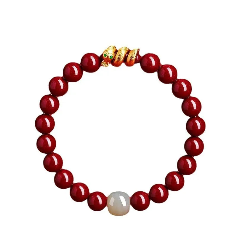 Handmade red cinnabar bracelet with snake Zodiac bead on a wrist, showing 8mm bead size.