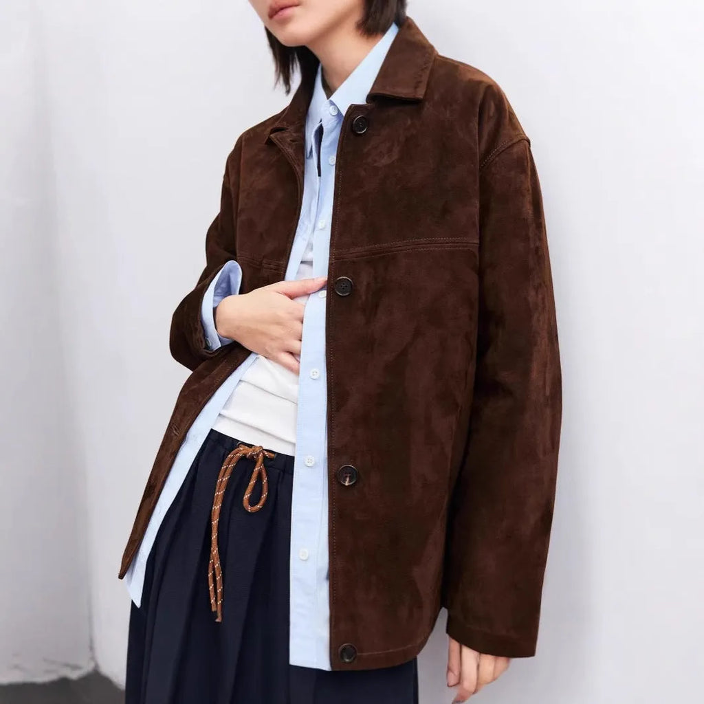 Women's mid-length caramel mocha cashmere coat with Peter Pan collar and leather stitching detail.
