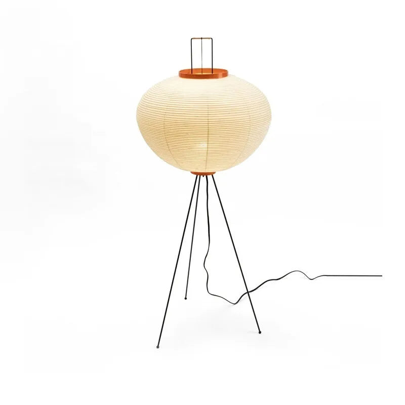 Japanese style handmade rice paper lantern table lamp with aluminium base on a wooden table.