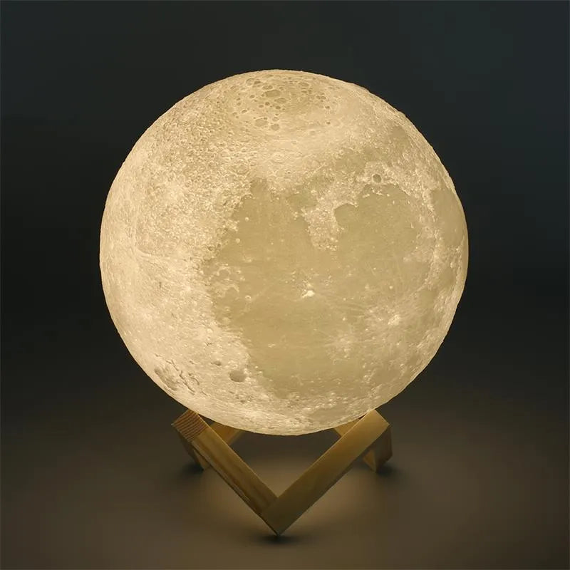 3D printed moon lamp glowing on a wood stand, showing detailed crater texture.