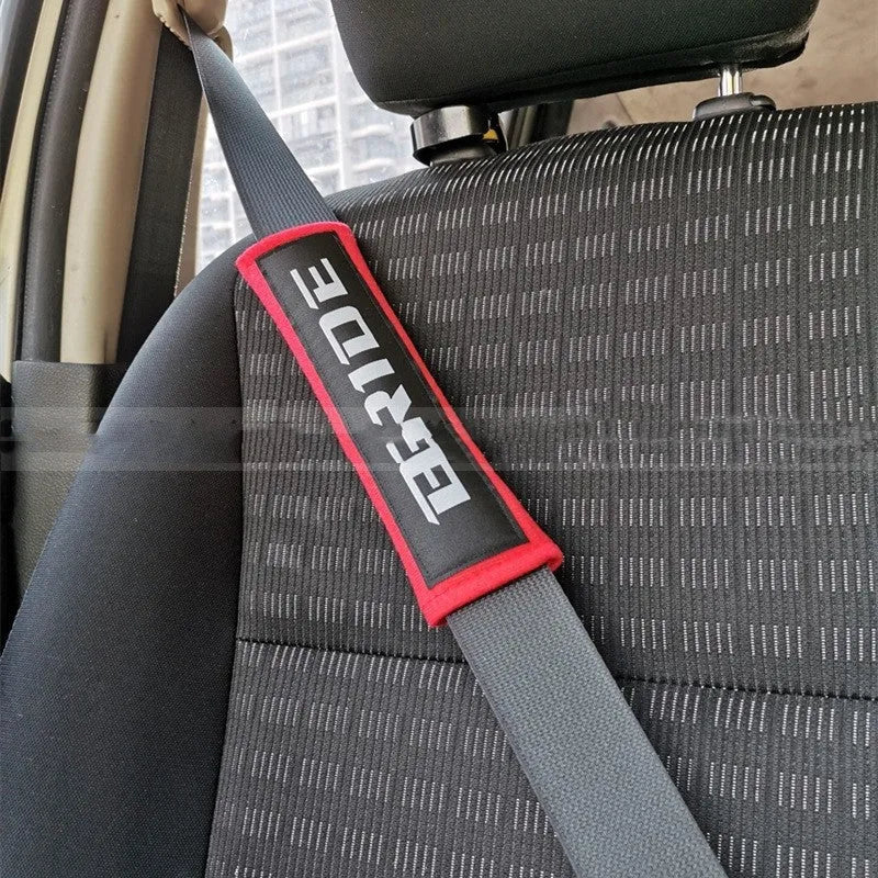 Black cotton sponge cloth car seat belt shoulder pad showing embroidery weaving texture and 22.5cm length