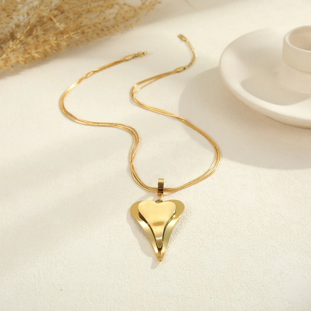 Stainless steel geometric snake bones chain necklace with double heart pendant in gold finish