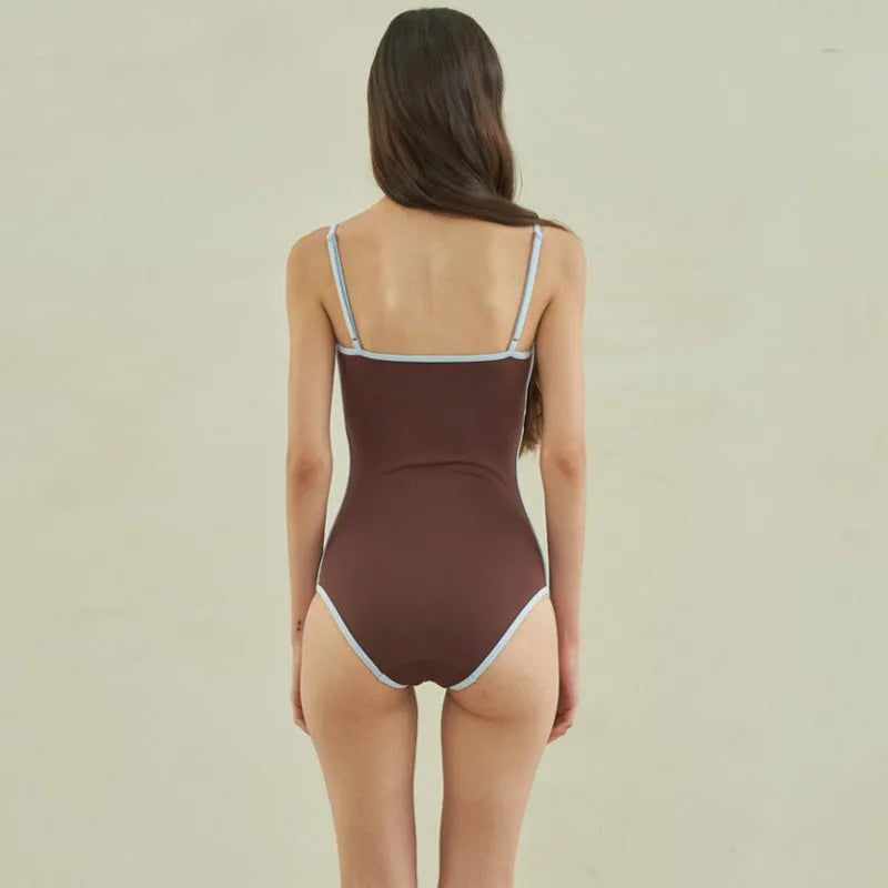 Brown one-piece swimsuit for women with triangle neckline on a mannequin