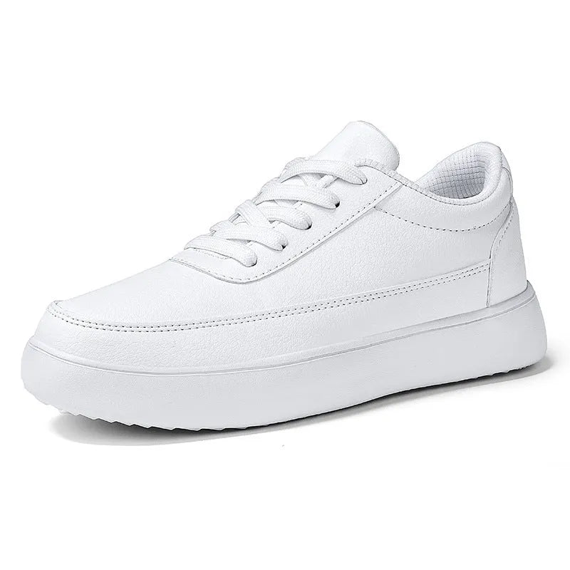 Women's white leather lace-up casual flat trainers on a plain background.