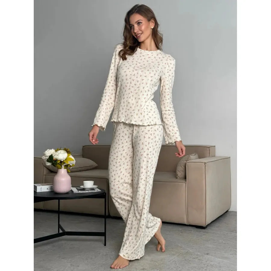 White women's floral print bell sleeve top and wide leg pants casual suit set laid flat