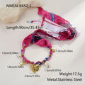 Gold-plated geometric love pendant necklace and matching bracelet jewellery set on display