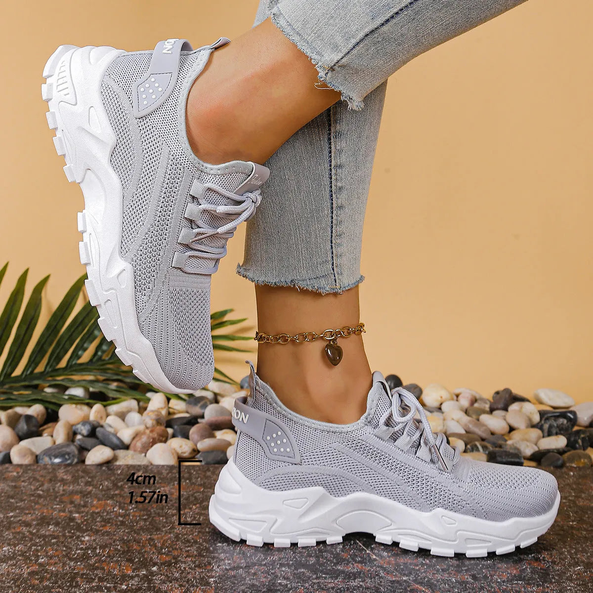 Women's low-top mesh sports sneakers in beige with front lace-up and a subtle platform sole.