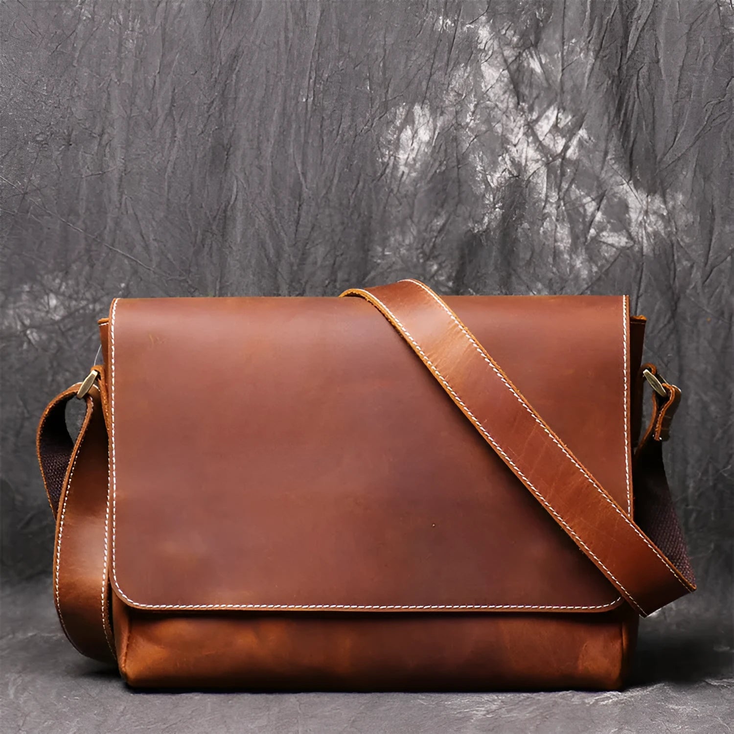 Men's vintage brown leather messenger bag with organised interior compartments and crossbody strap