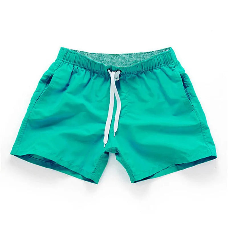 Men's polyester beach shorts with straight leg opening in multiple colours including black, white, and fluorescent yellow
