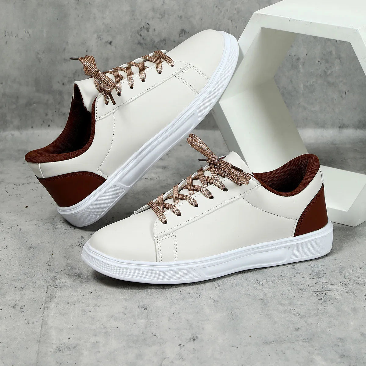 Beige brown platform skateboard sneaker with low top, round toe, and cross-belt design on a white background.