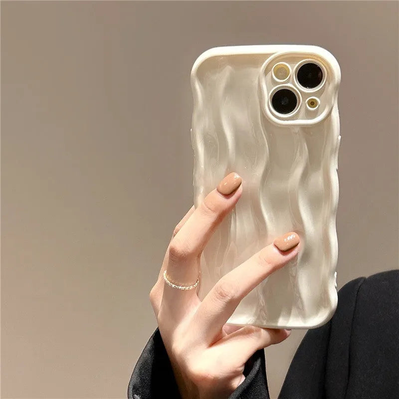 Silicone iPhone case with water ripple texture in green, shown on an iPhone 17 model