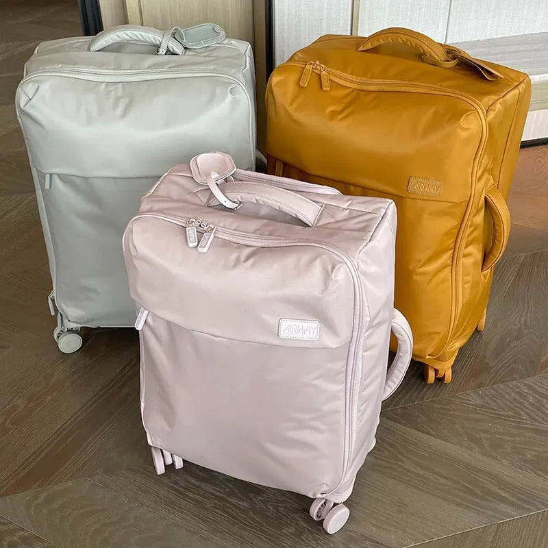 Ultra-light waterproof Oxford cloth suitcase with universal wheels in a bluestone green colour.