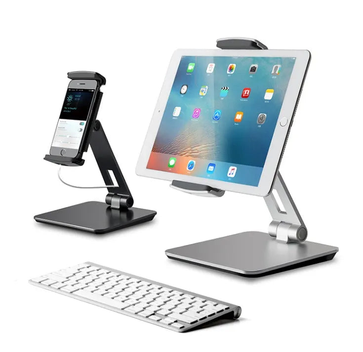 Folding aluminium phone and tablet stand on a desk, shown in silver colour with 360-degree rotation.