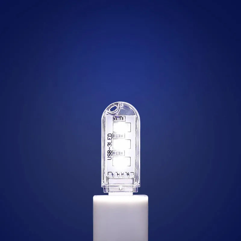 Small white LED baby night light with USB cable, measuring 6cm by 1.8cm