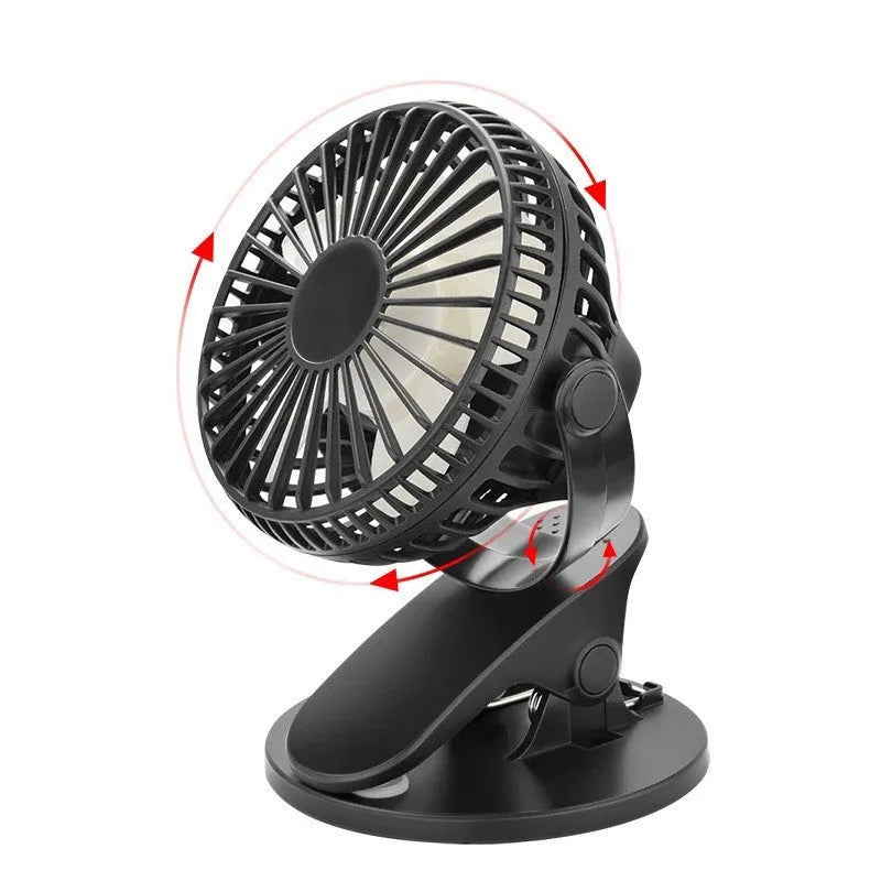 Small white USB rechargeable clip fan attached to a desk edge.