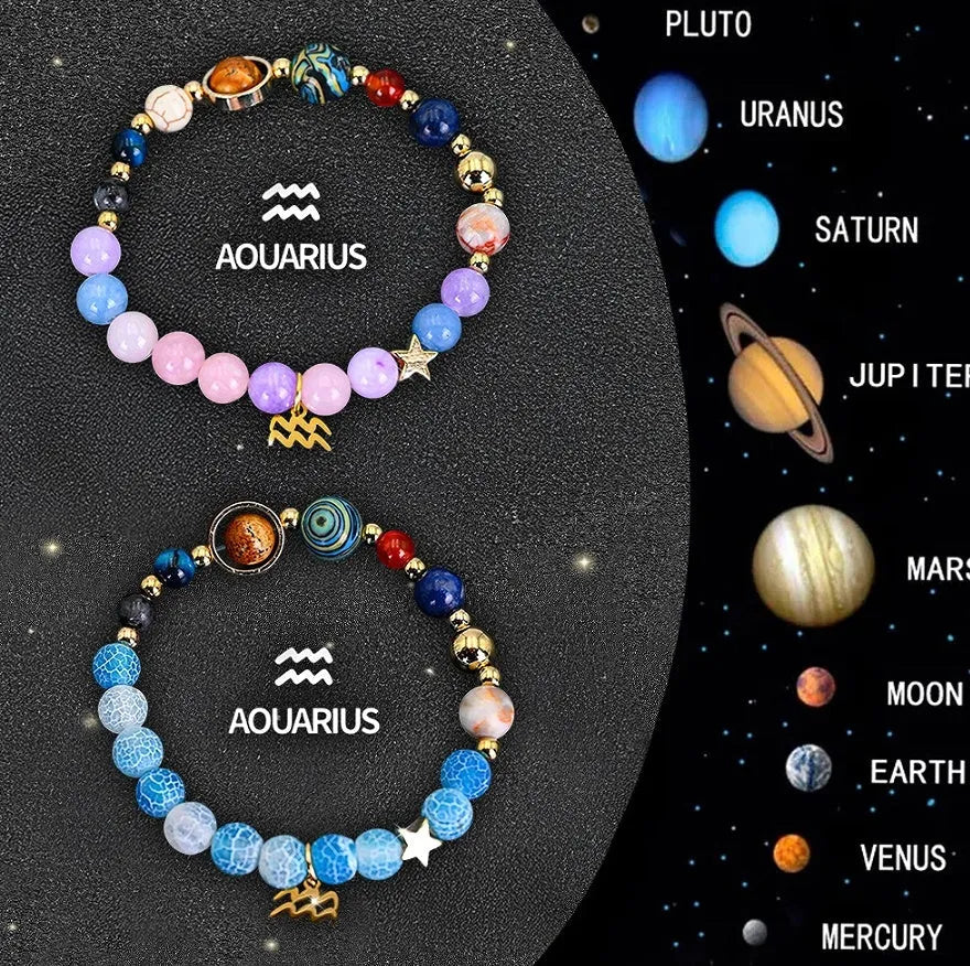Set of two natural stone beaded bracelets with zodiac charms on a textured background.