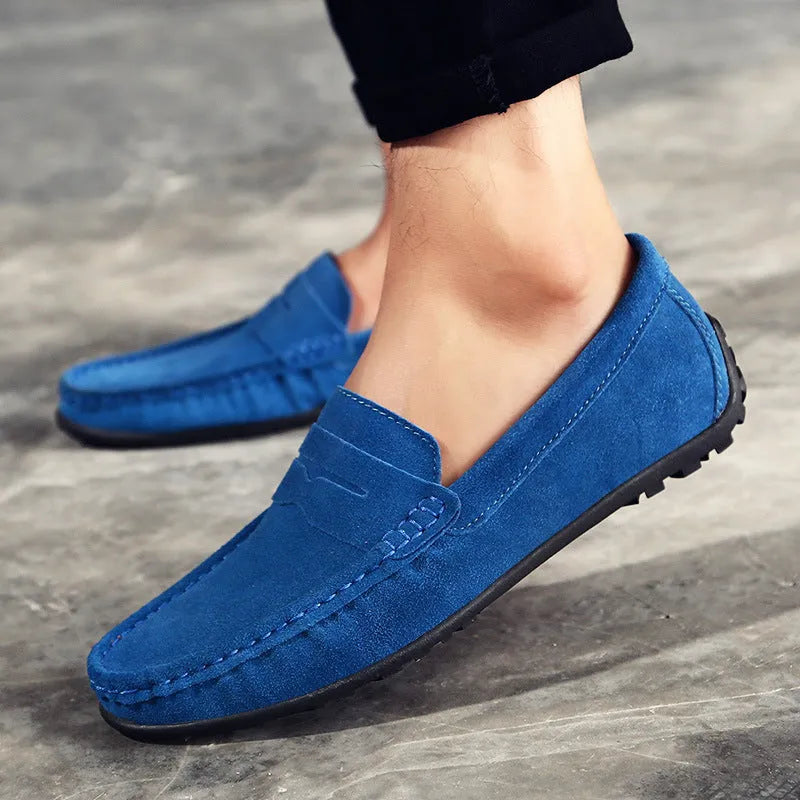 Men's brown suede casual loafers with a round toe and flat rubber sole on a white background.