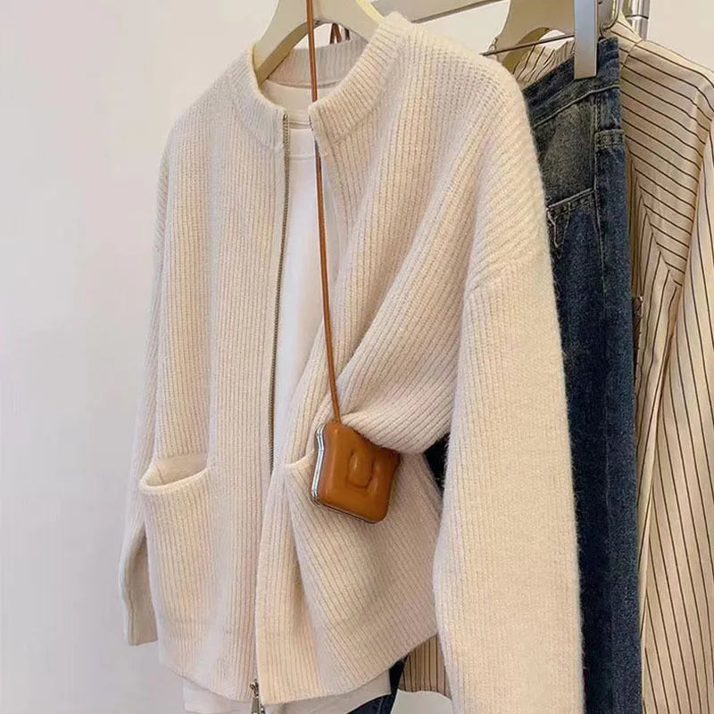 Beige viscose knit cardigan coat with long sleeves on a hanger.