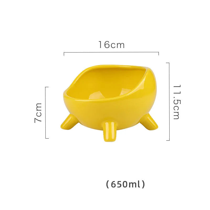 Green ceramic cat food bowl with four-leg stability base on wooden floor