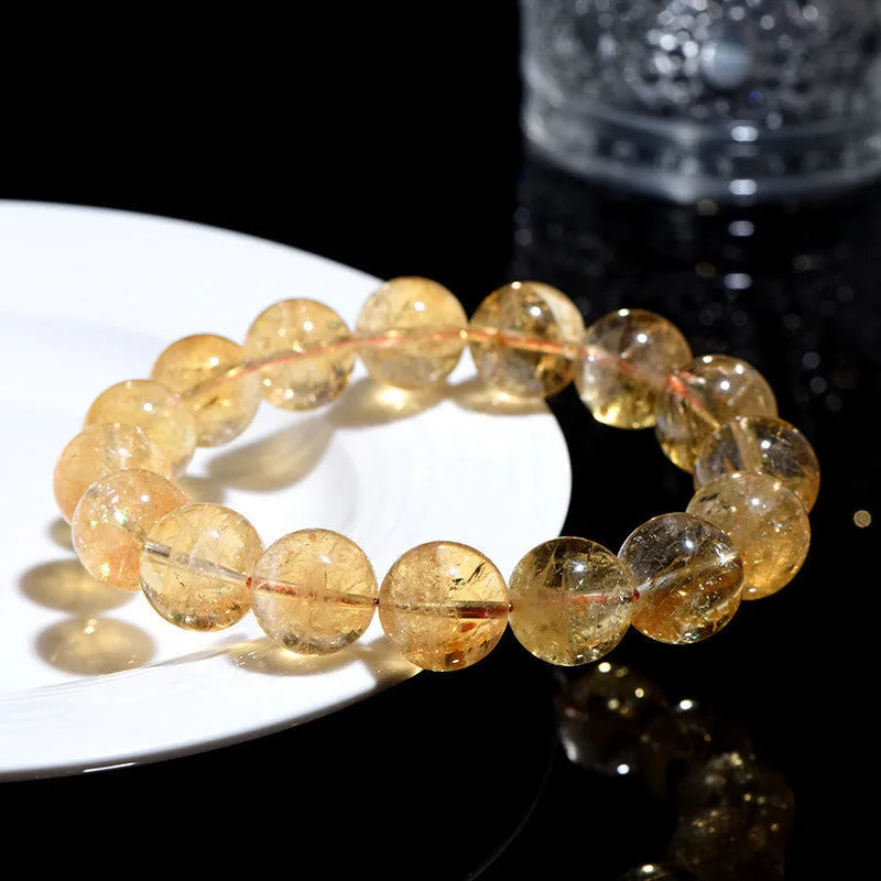 Natural yellow citrine gemstone bead bracelet showing geometrical beads on a string.