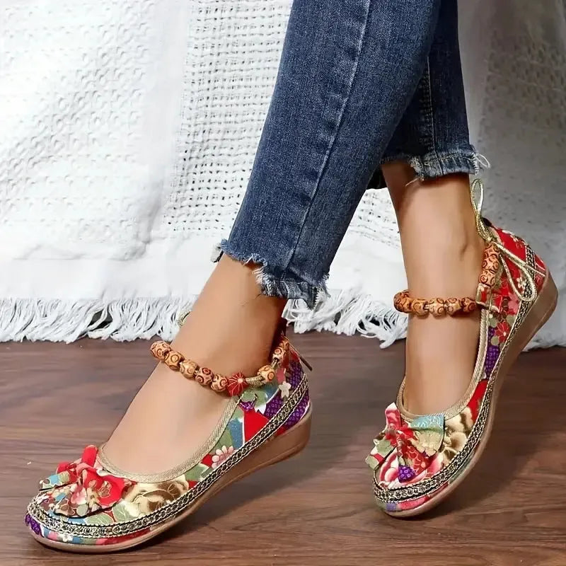 Women's ethnic platform sandals with elastic band closure in black colour showing cloth upper and round toe design
