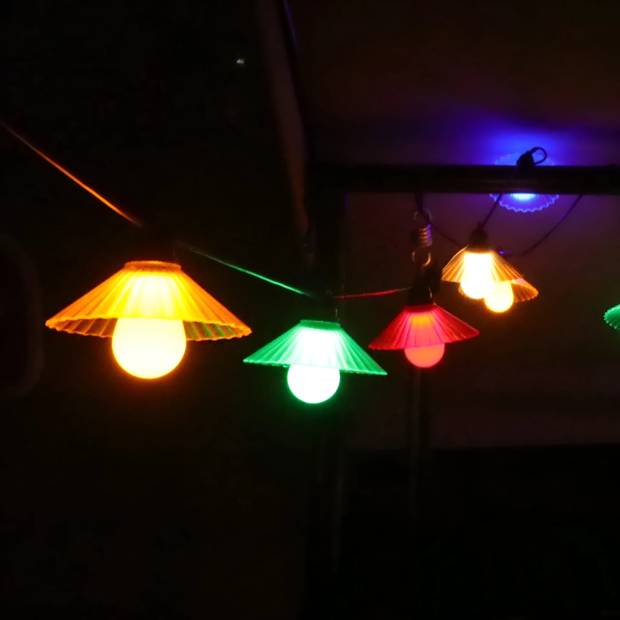 Outdoor LED string lights with flower-shaped bulbs in warm white and coloured options for garden and camping